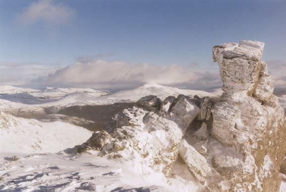 The summit rocks, with Ben Lomond disappearing into the
           cloud in the distance.